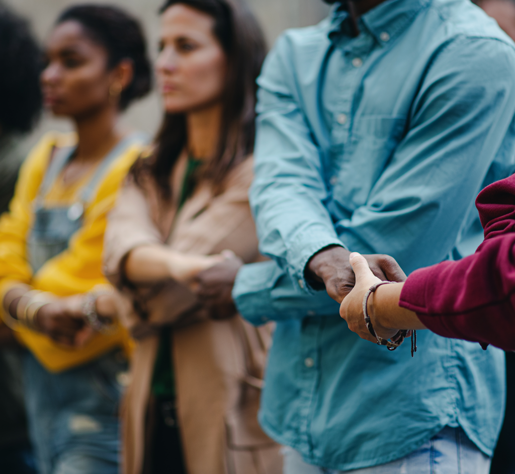 line of people with interlocking holding hands