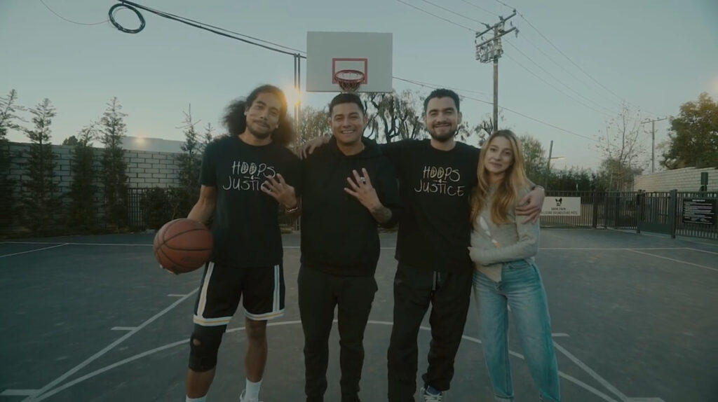 Hoops 4 Justice picture featuring 1 woman and 3 men, 2 are wearing Hoops 4 Justice t-shirts.